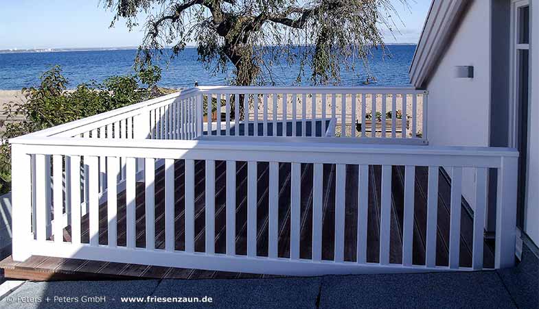 Holzterrasse mit herlischem Ausblick auf die Ostsee und einem weißem Terrassengeländer von Peters + Peters - Qualität mit 25 Jahren Garantie.
